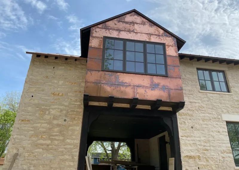 Copper metal panel facade on a stone building for Roof Repair in Los Lunas